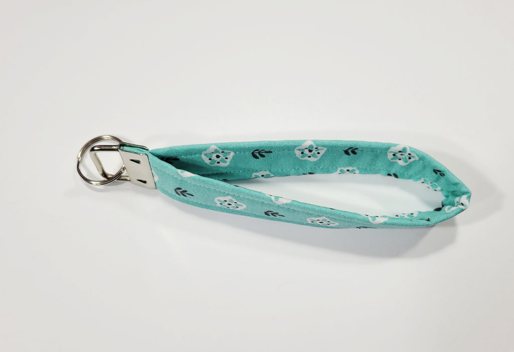 White Flower on Teal Wristlet Keychain